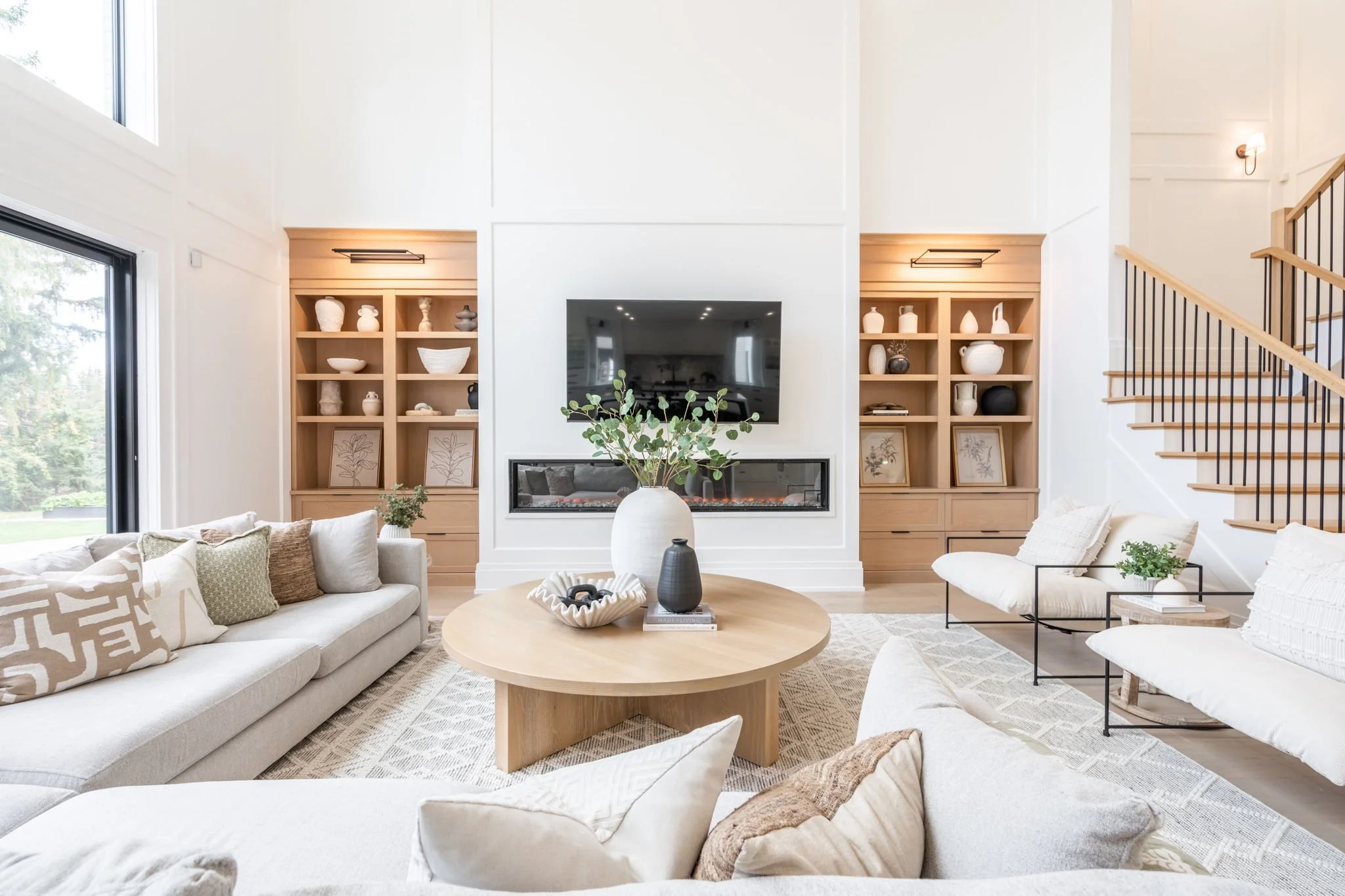 Living room with built-in shelving and fireplace luxury interior design in Oakville Ontario by JT & Co Interiors
