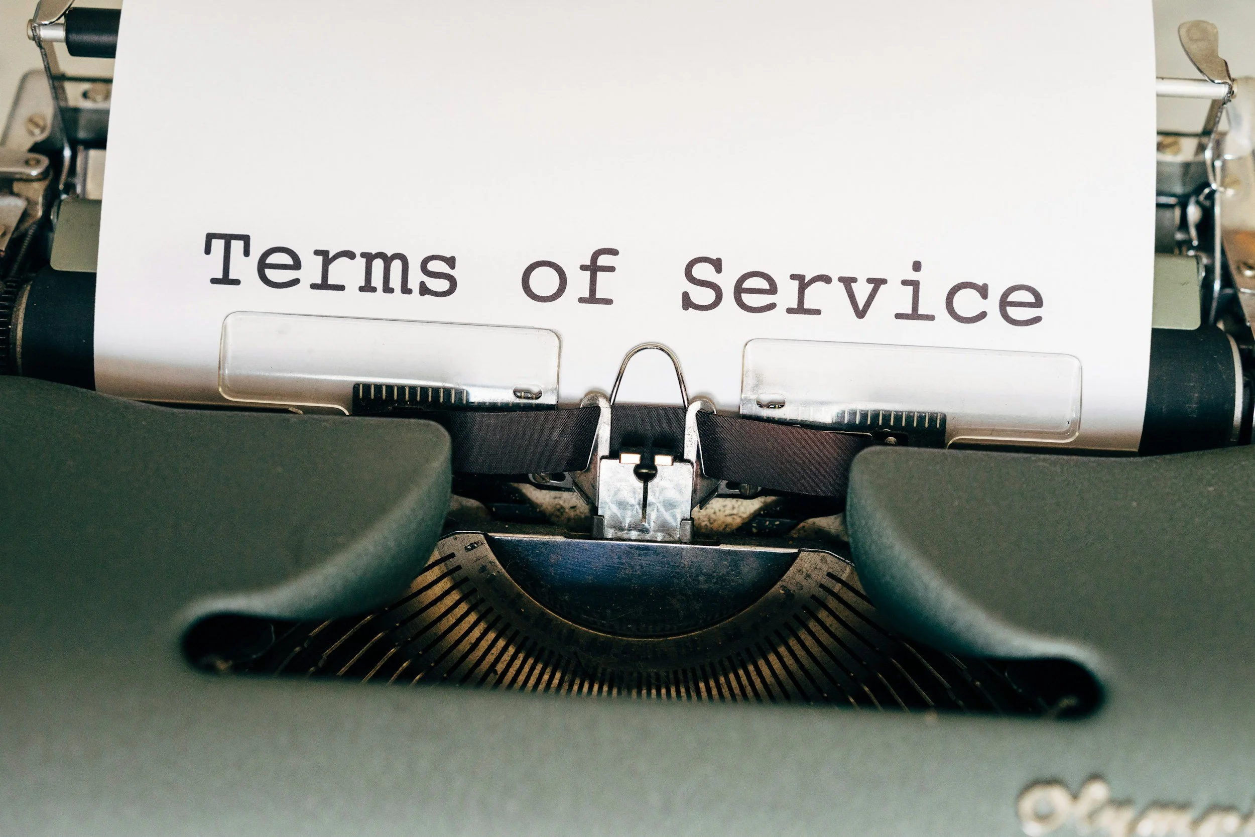 Typewriter with a paper that has 'Terms of Service' written on it.
