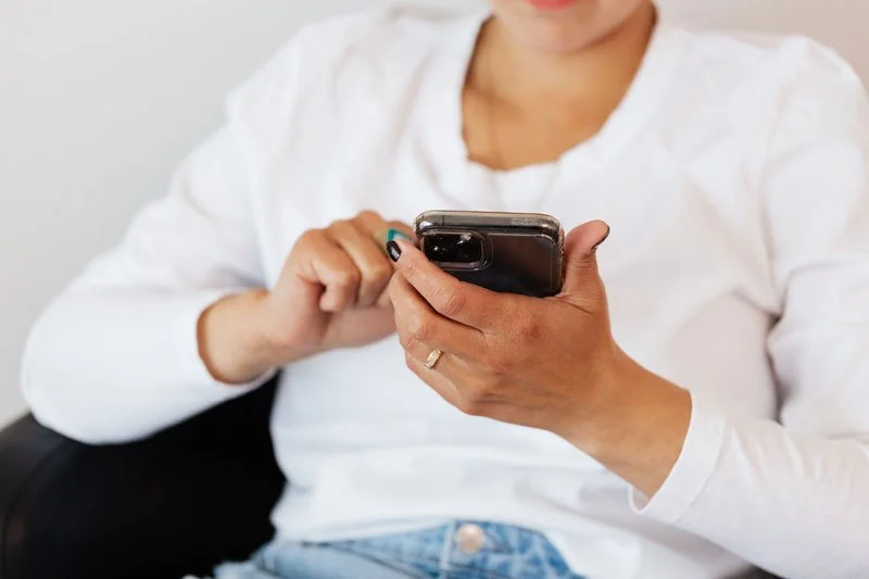Woman on her phone using the Vault App and making a confession, releasing a truth or just talking about a fantasy.
