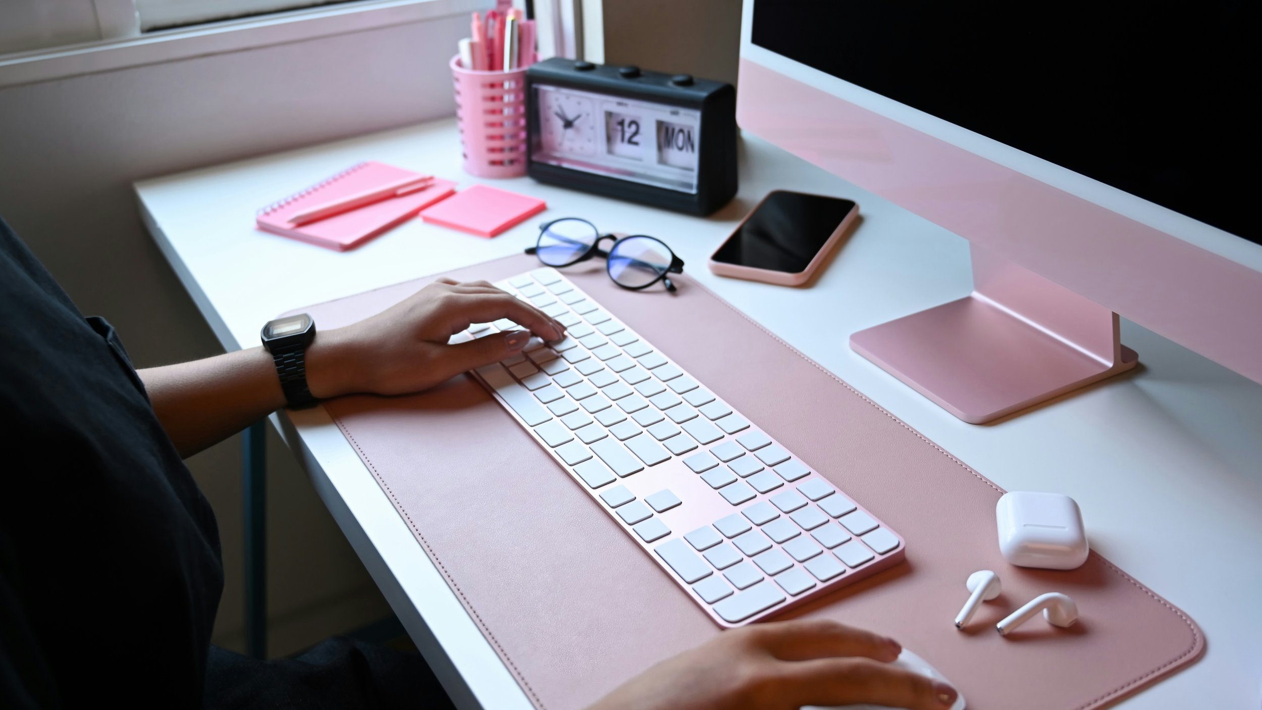 Ancona Creative work setup on a desk with pink elements