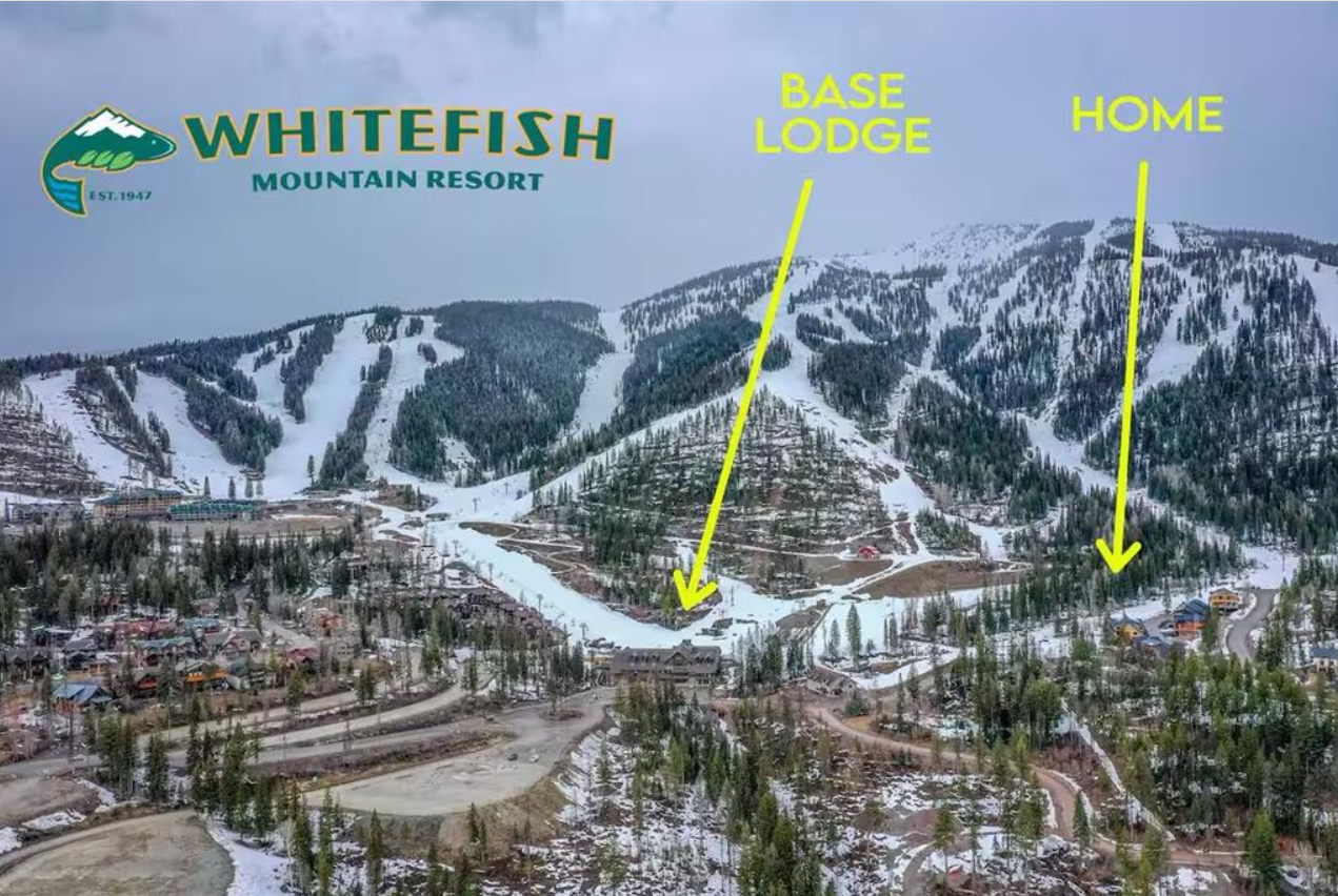 A scenic mountain resort with ski slopes, labeled as Whitefish Mountain Resort. The image points out the Base Lodge and the Home buildings using yellow arrows.