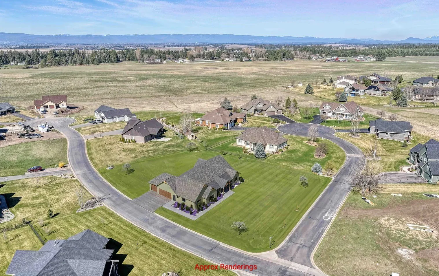 A suburban neighborhood with newly built single-family homes, winding streets, green lawns, and open fields in the background under a partly cloudy sky.