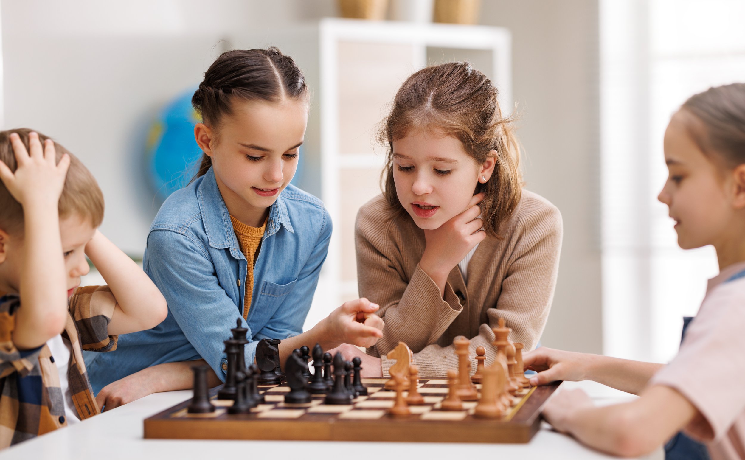 group of 4 kids playing chess.jpg