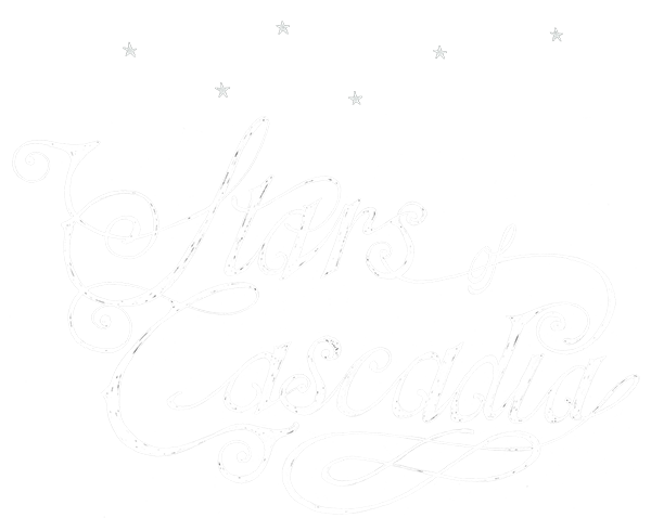 Logo for the band Stars of Cascadia, a white, hand-drawn elegant western-style script with six stars in a constellation pattern above it
