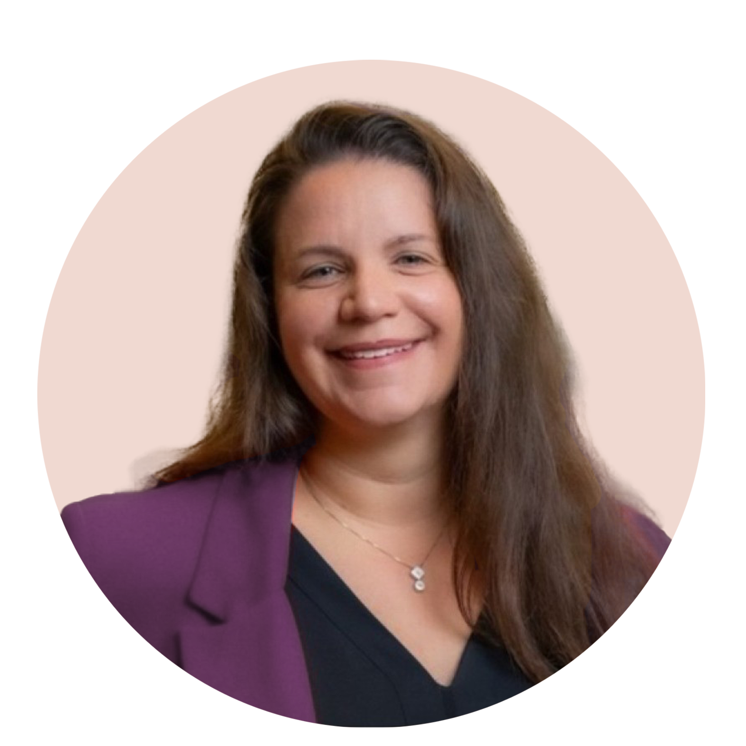 A smiling woman with long brown hair wearing a purple blazer and a black top, accessorized with a necklace, against a light beige background.
