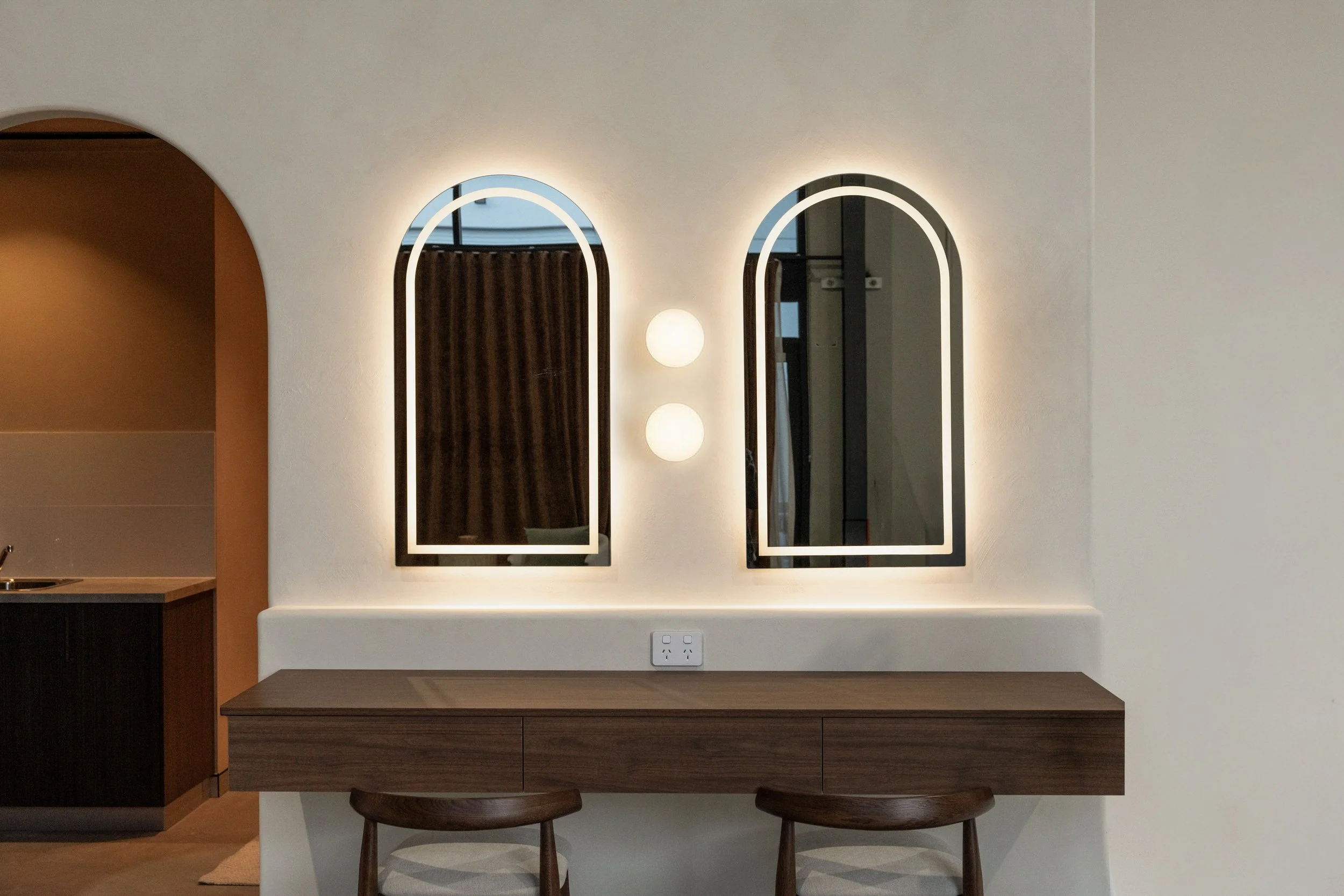 Premium makeup station with light up vanity mirrors, walnut desk and stools and feature lighting