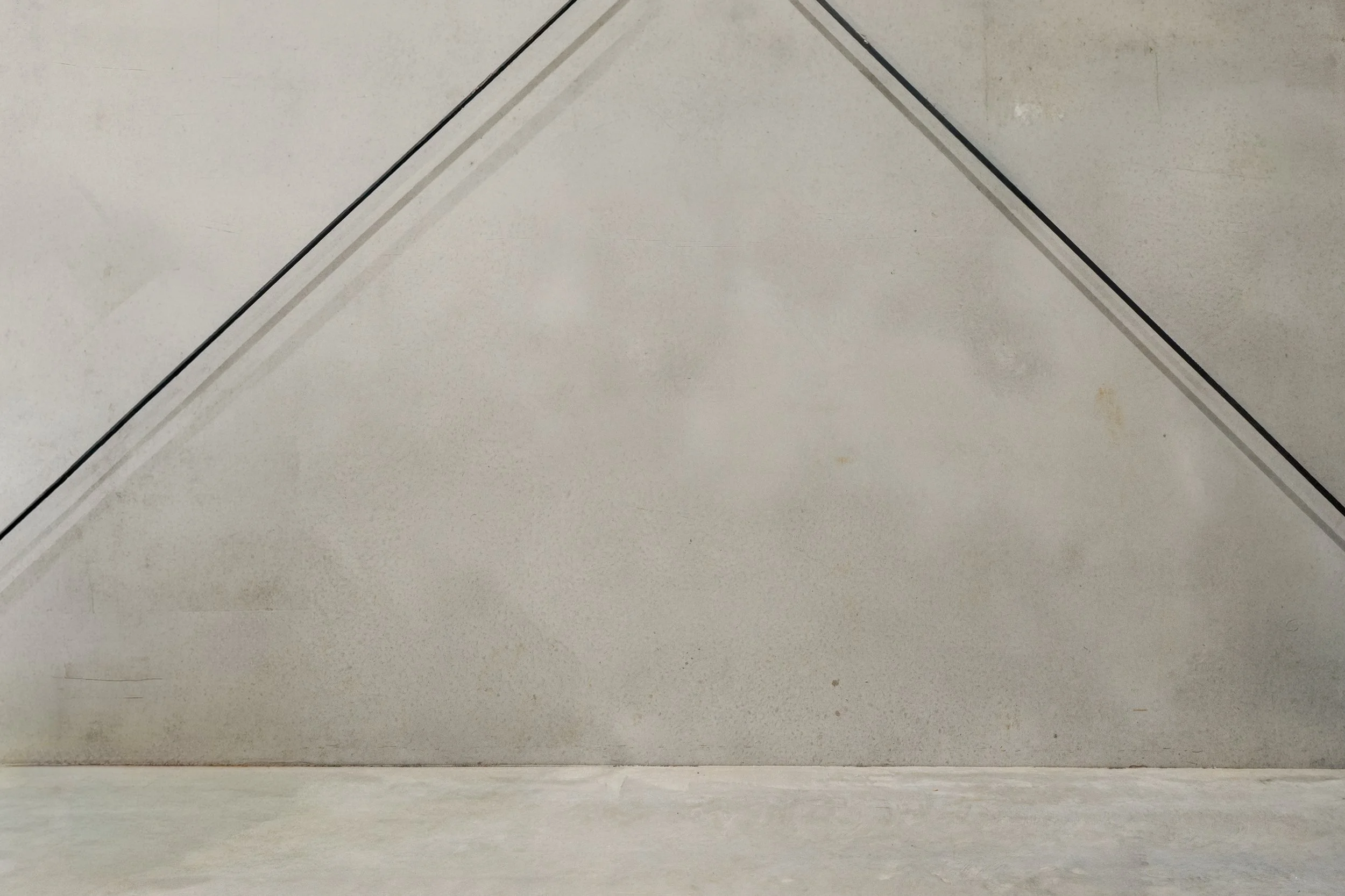 Clean, concrete wall and flooring with metal bracing showing an industrial aesthetic