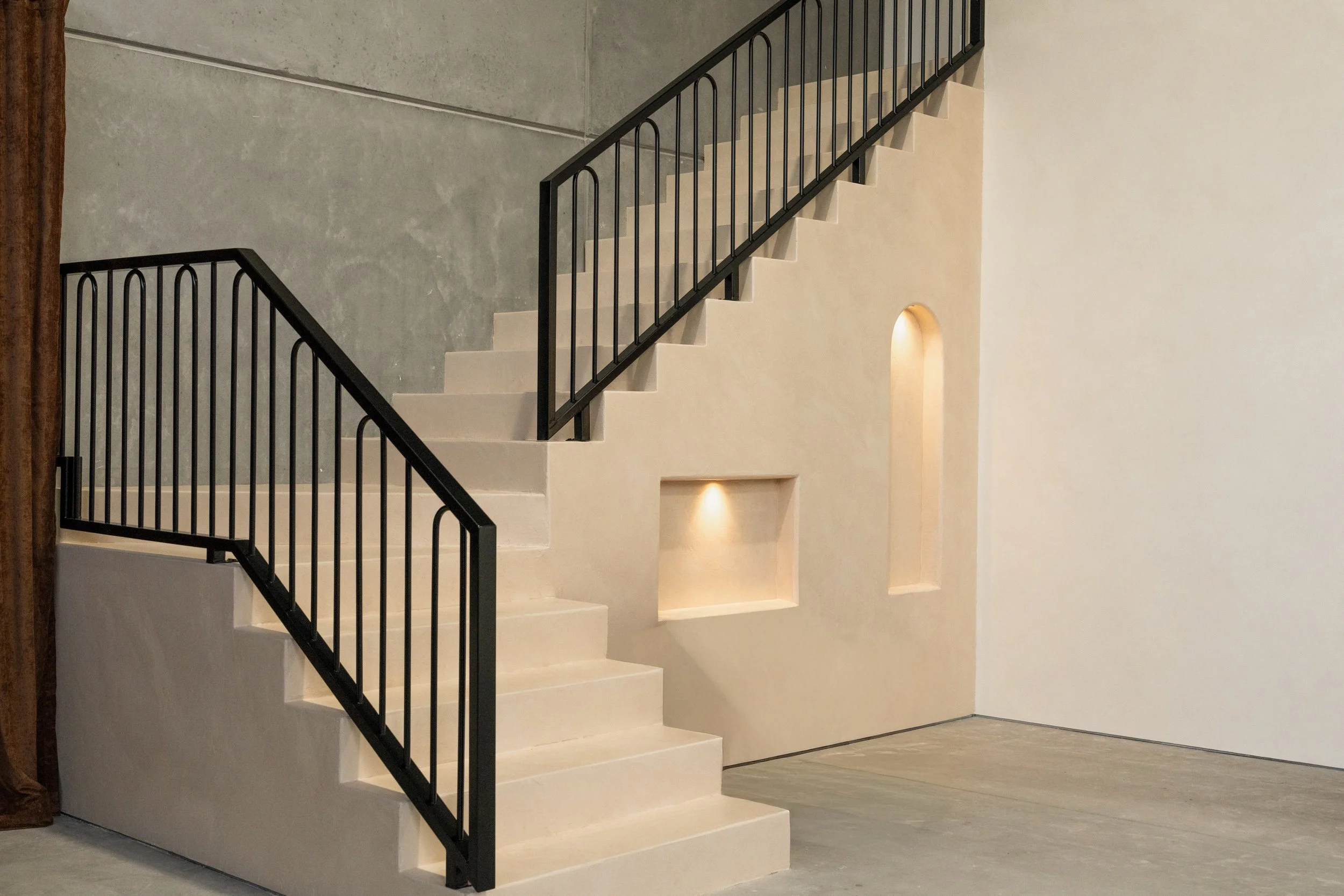 Micro-cemented staircase with elegant niche boxes and premium balustrades