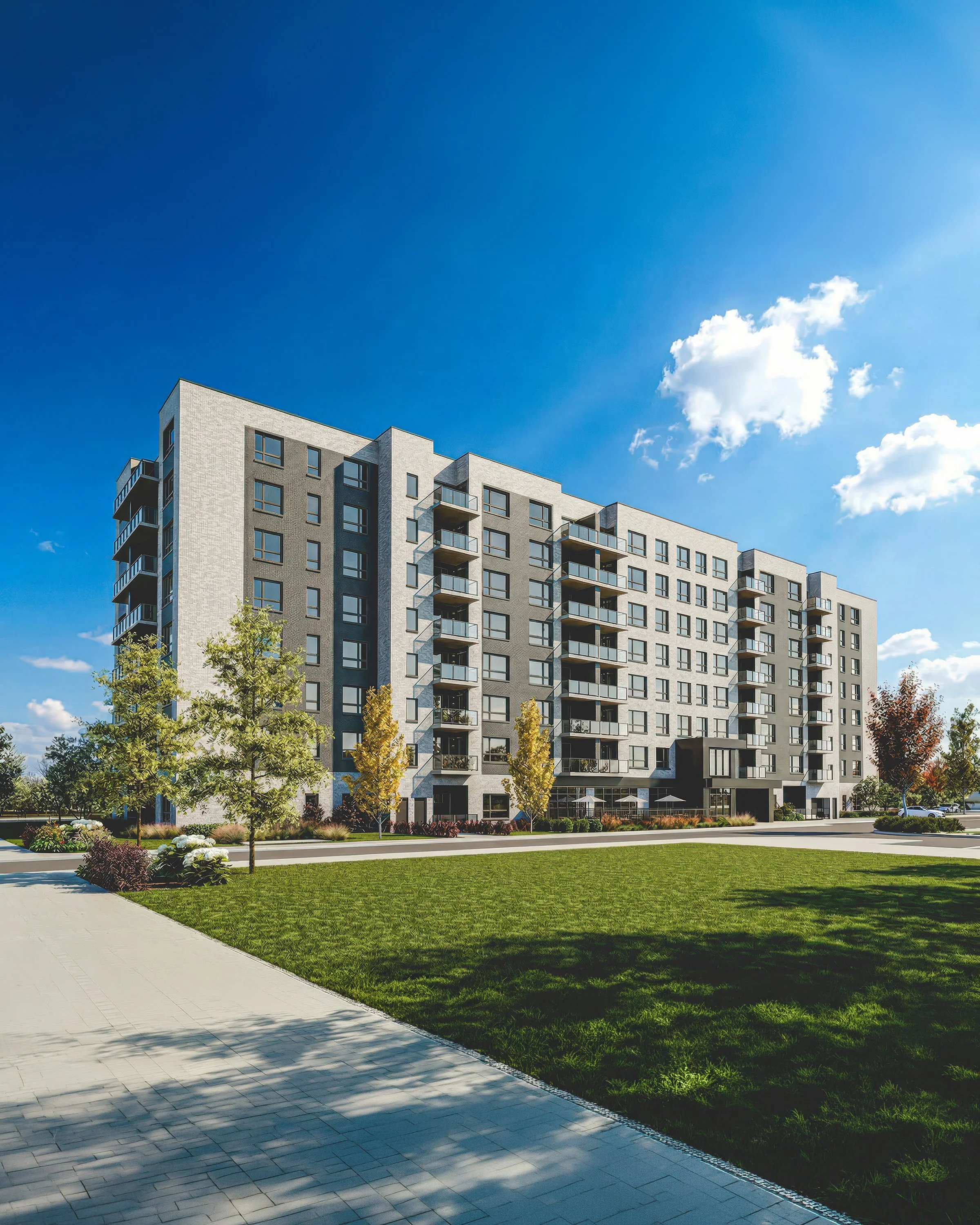 Modern apartment building with balconies, surrounded by trees and green lawn, under a blue sky with some clouds.