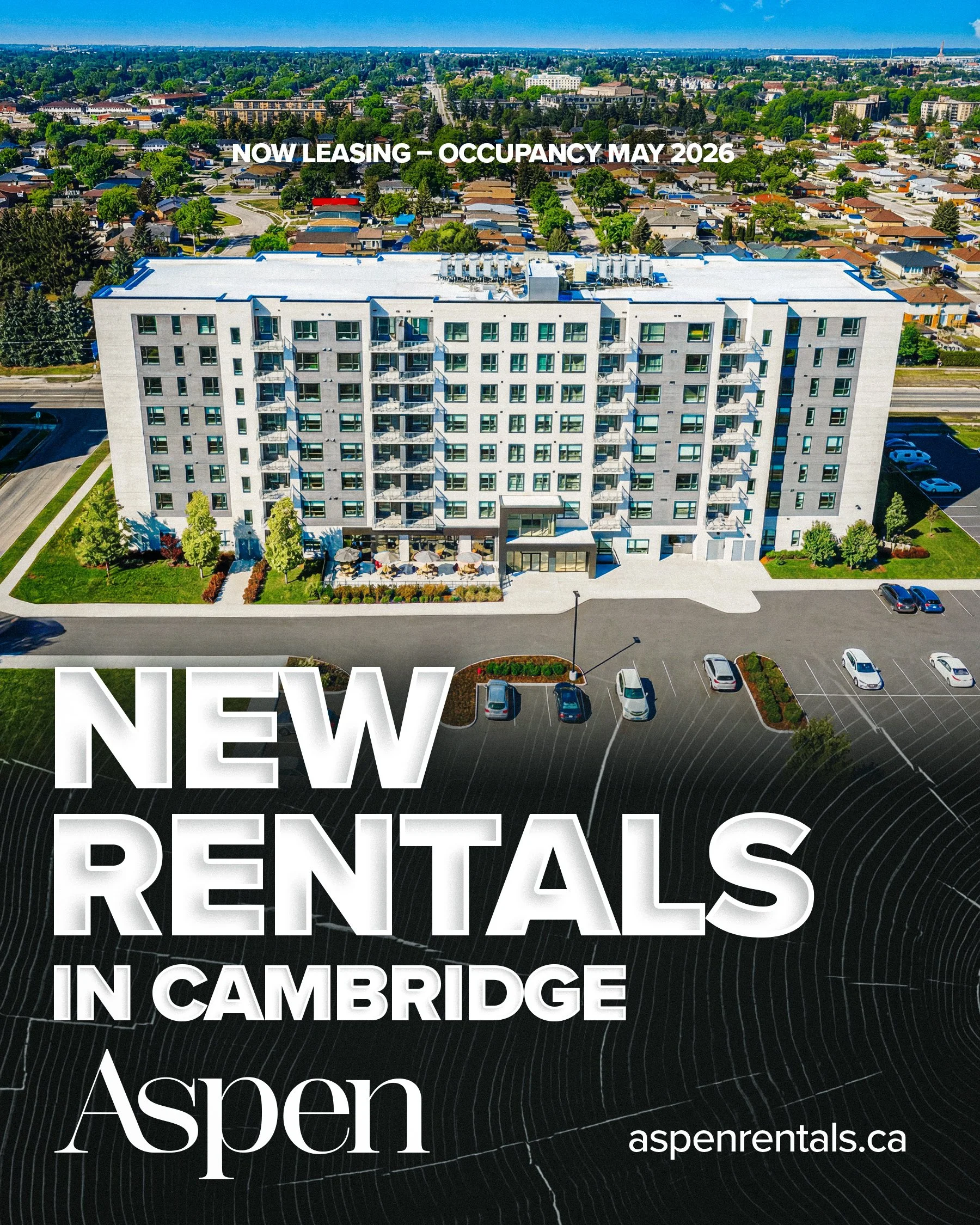 Aerial view of a modern white apartment building with parking lot and surrounding trees, with green residential neighborhood in background; overlay text announcing new rentals in Cambridge, Aspen, with website aspenrentals.ca.