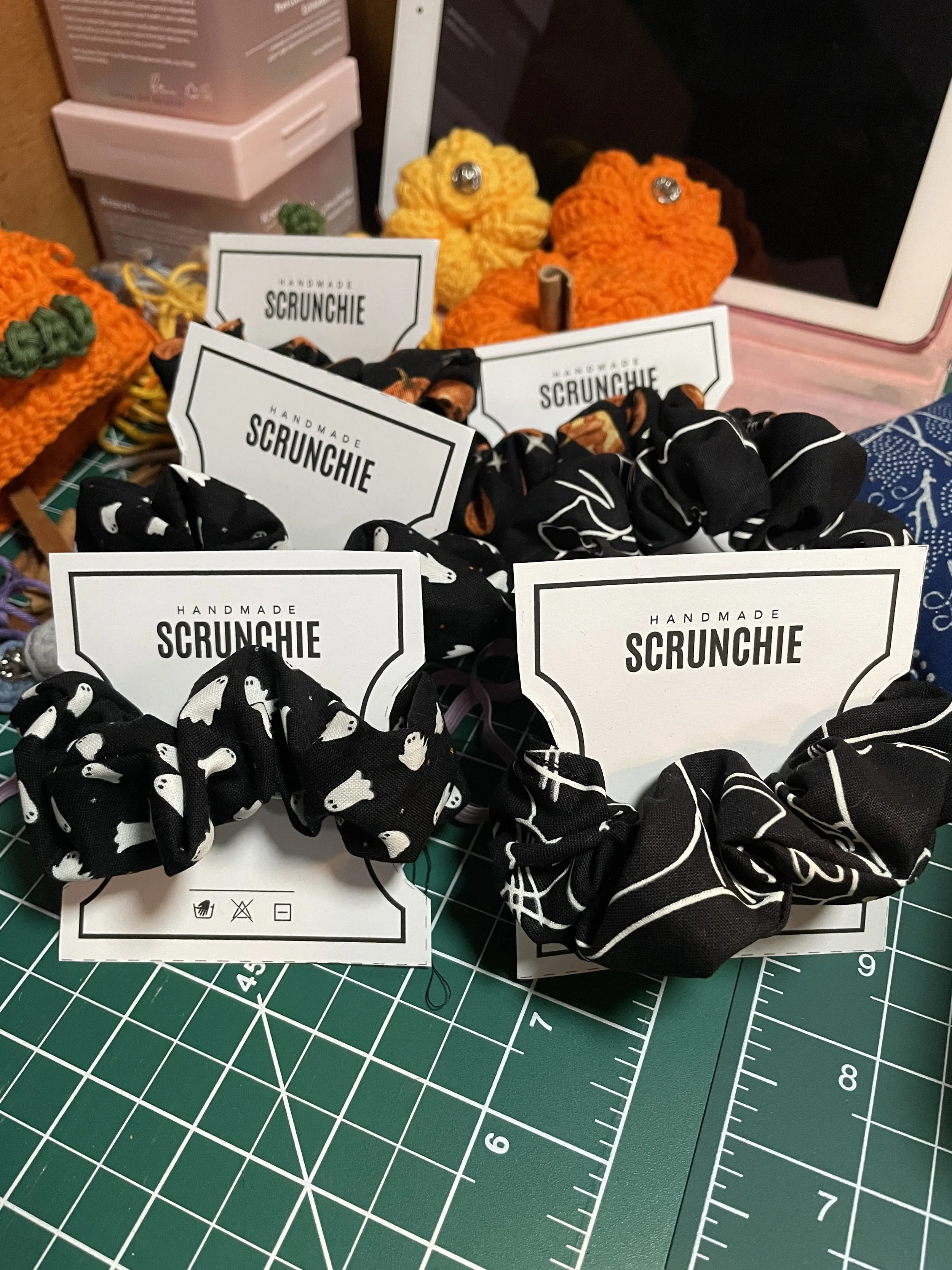 Scrunchies made of 4 patterns of fabriuc: black cats, little ghosts orange pumpkins and grey pumpkins