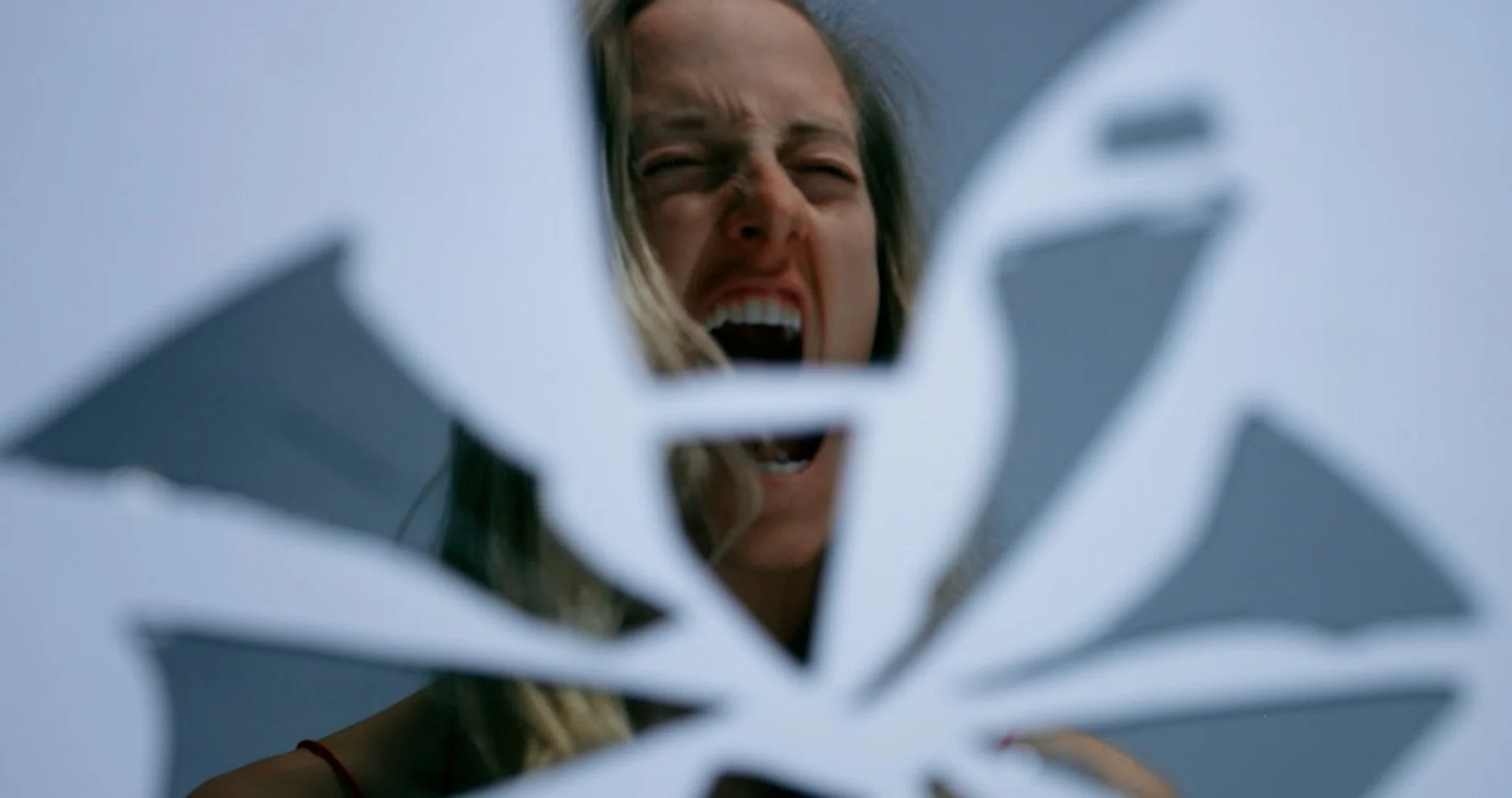 Michaela Ellingson performing an emotional artistic piece with mirrors reflecting anger.