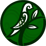 Close-up of a stylized, cartoonish green face with a mischievous grin and swirling patterns.