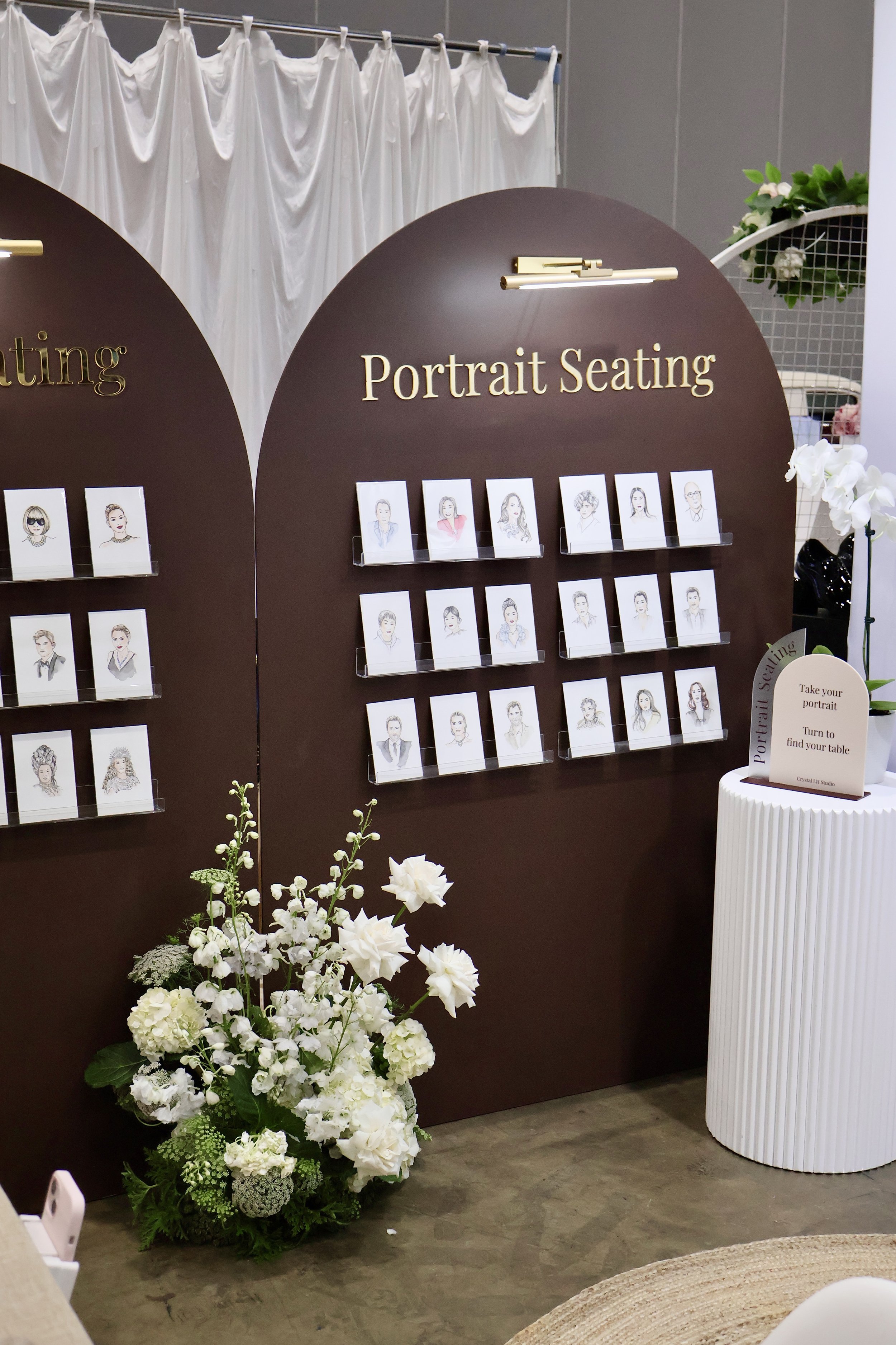 Large Portrait Seating installation with hand-drawn guest portraits and floral styling