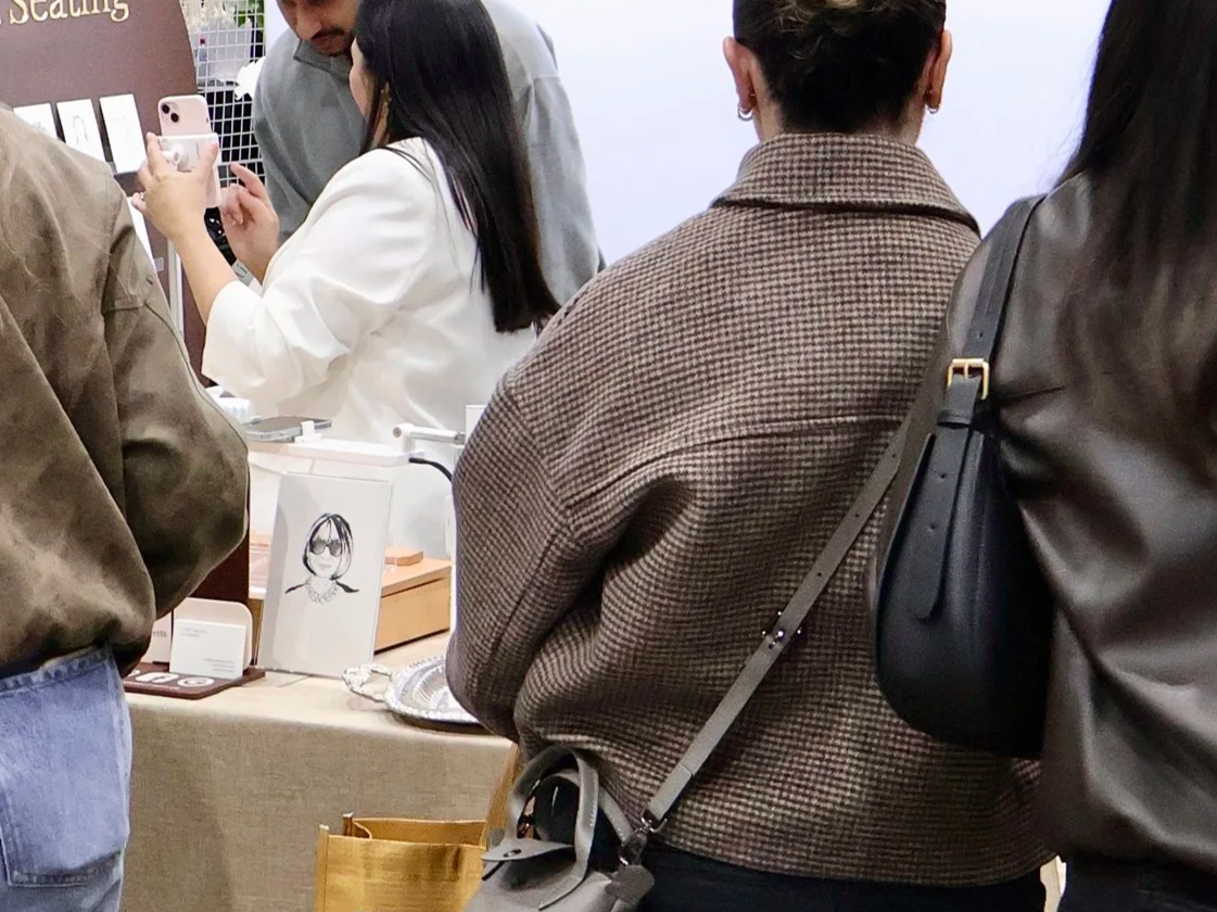 Guests engaging with a portrait illustration activation by Crystal LH Studio in Melbourne