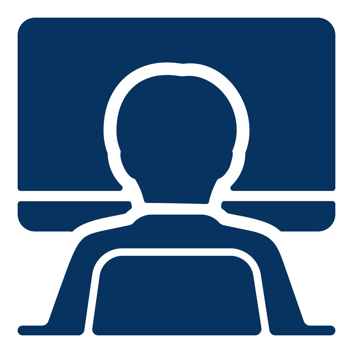 Icon of a person sitting at a desk looking at a computer monitor.