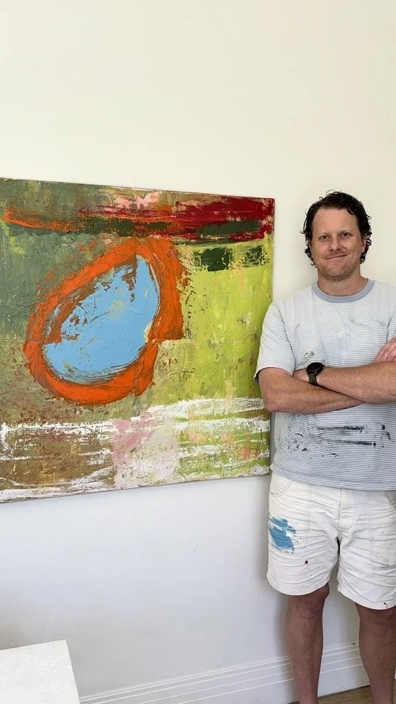 Thomas Cain, Melbourne abstract painter, standing beside his painting Gumnut 2.0