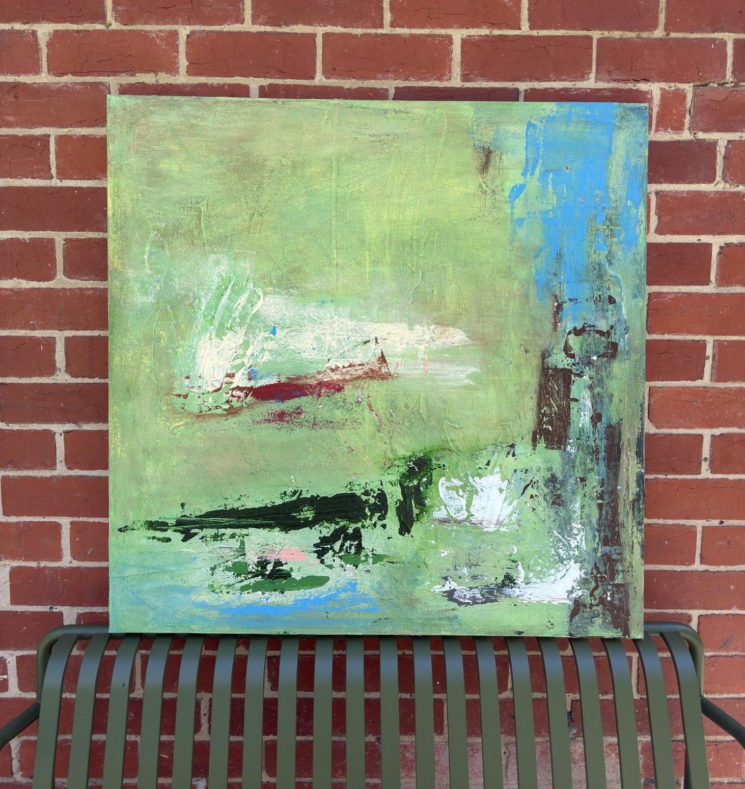 Seaside by Thomas Cain resting on a green bench against a red brick wall
