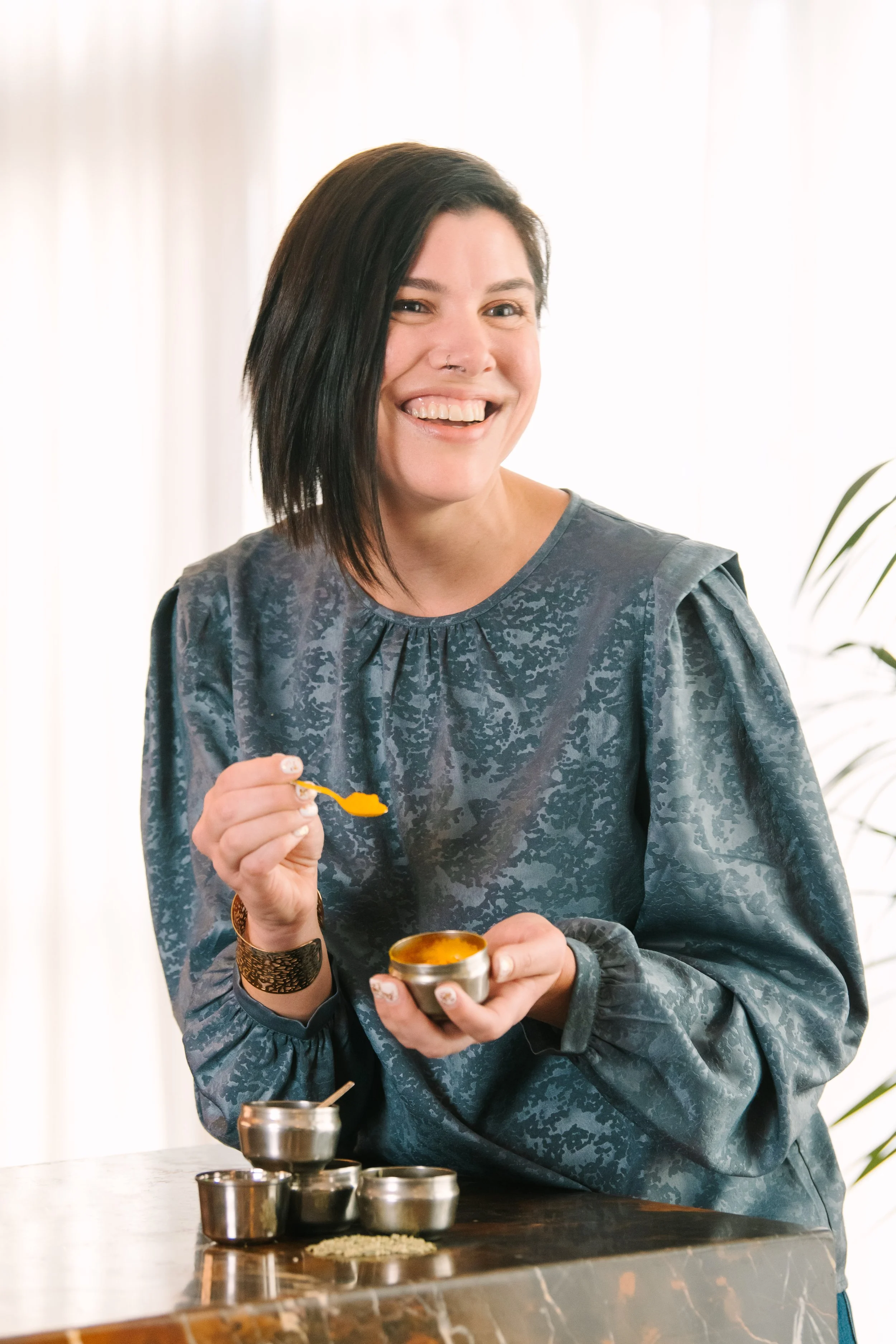 Founder of Simpli Spiced holding spices and tasting seasoning