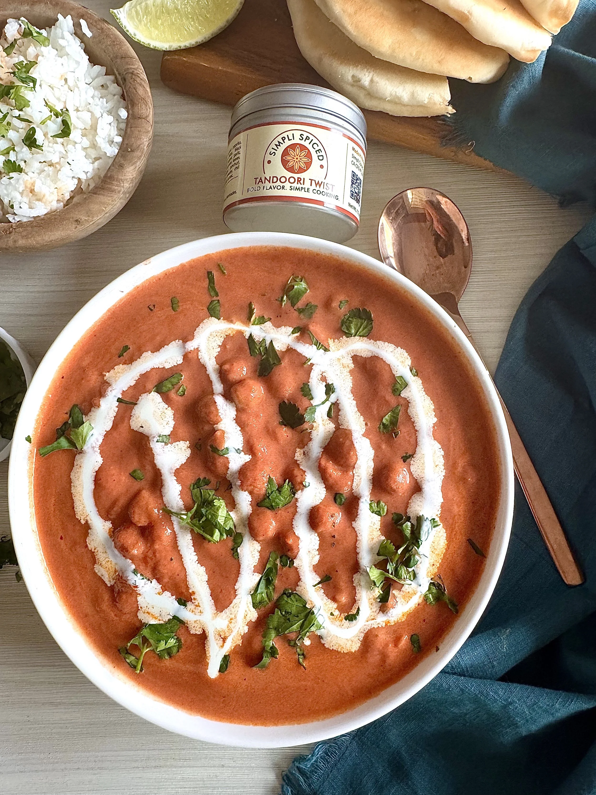 Vegetarian butter chickpea curry with creamy tomato sauce and chickpeas served with rice and naan (vegetarian)