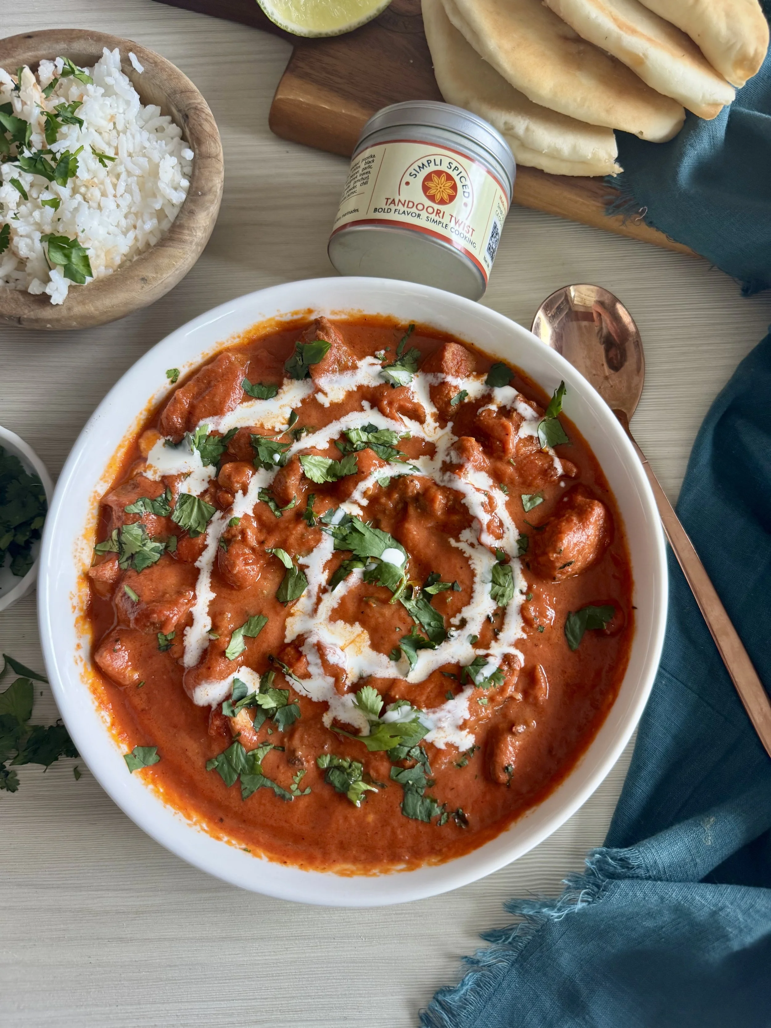 Butter chicken with creamy tomato sauce served with rice and naan