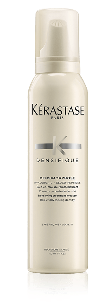 A white bottle of Kérastase Densifique Densimoreshampoo, designed for hair with thinning density, with a pump dispenser and black and gray text on the label.