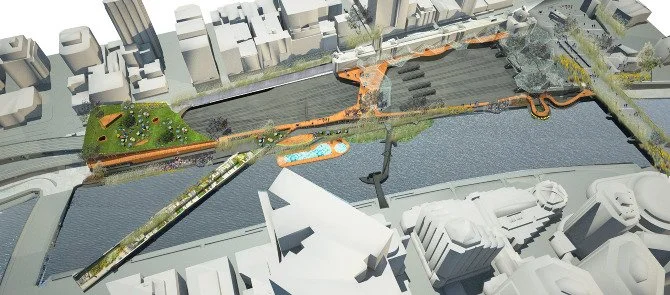 Bird's-eye view of an urban park with pathways, greenery, water feature, and surrounding buildings.