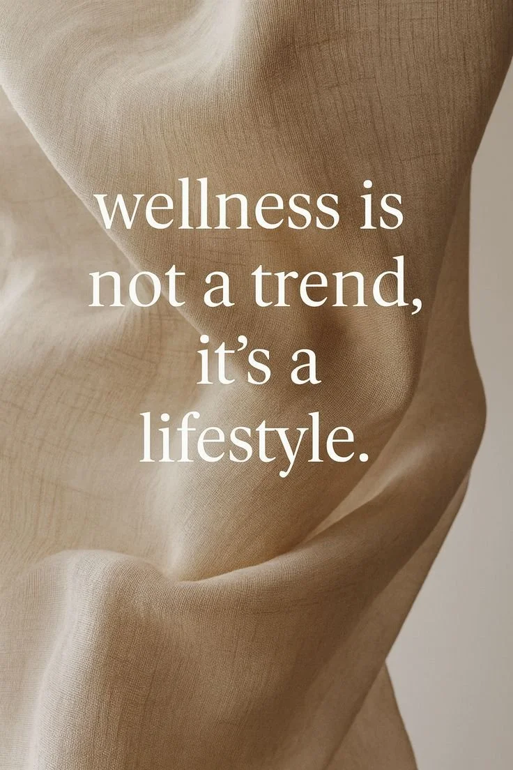 A beige fabric background with the quote 'wellness is not a trend, it's a lifestyle' written in white text.