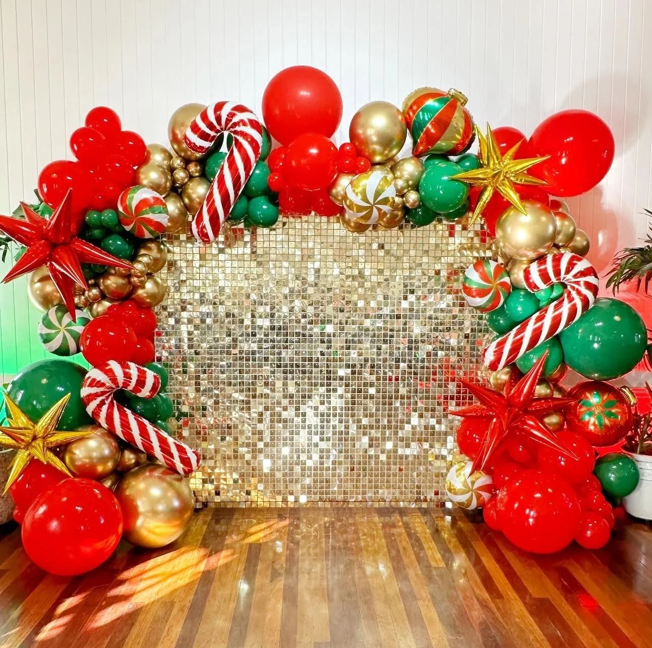 Christmas balloon garland and gold shimmer wall for a corporate Christmas party