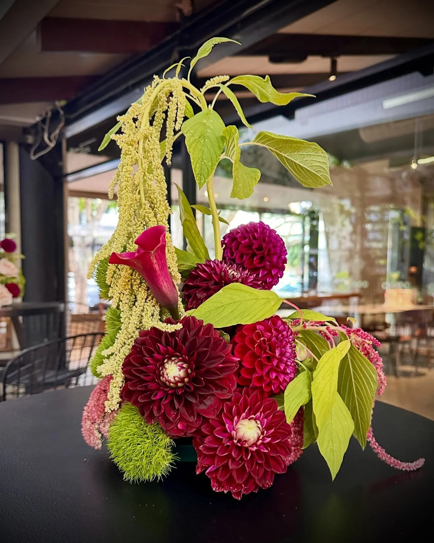 From flower arrangements to balloon decor, deep jewel tones are most certainly having a moment in wedding and party decor and we are crushing on it

We dove into this colour palette by creating a deep plum, sand and gold balloon wall around light up 