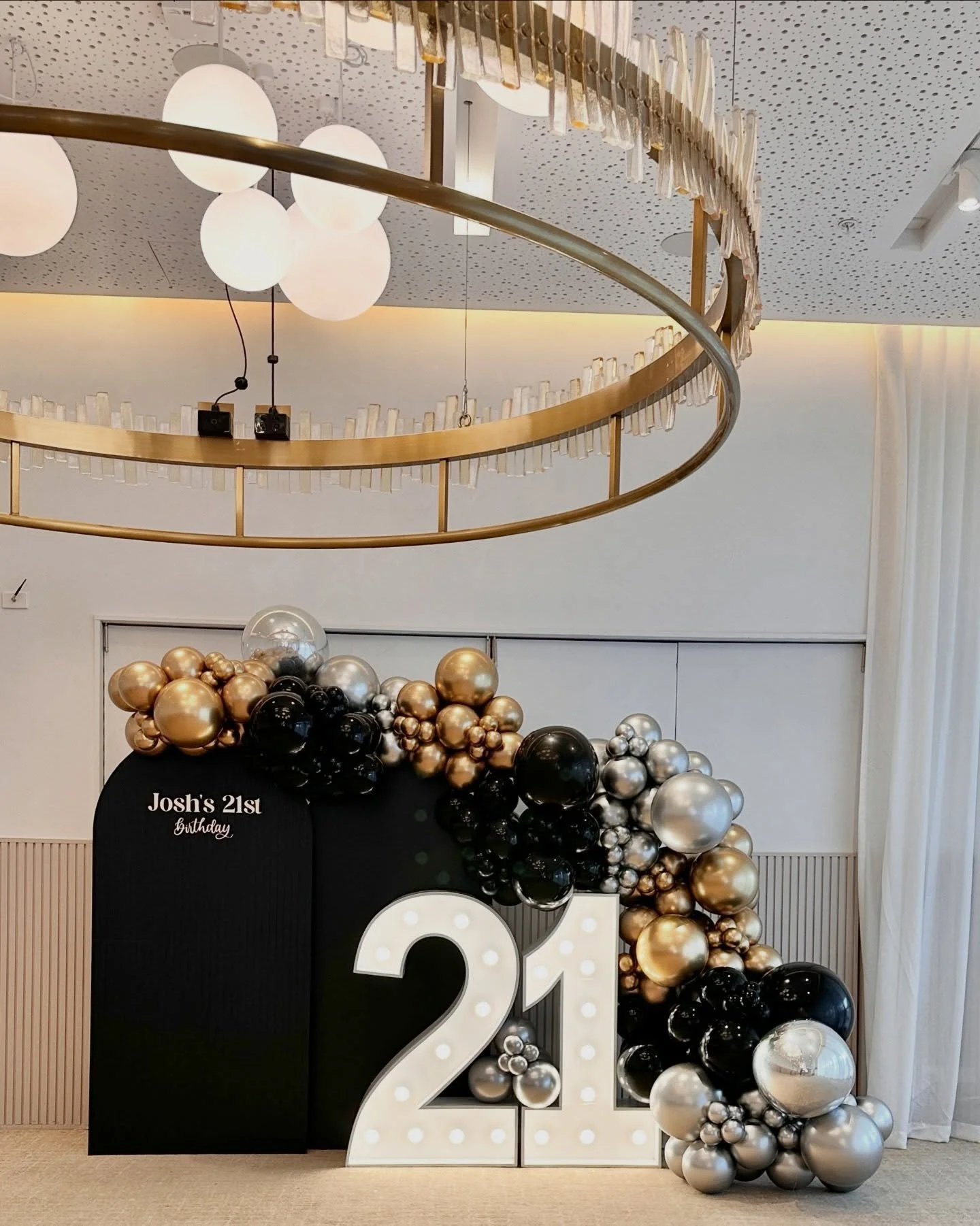 Twenty One 🖤 We love a bit of drama and we think our Classic Arch Backdrops, now available to hire in black, offer just that! 

We paired our black, gold and silver balloon arch backdrop with light up numbers to create a sophisticated vibe for Josh&