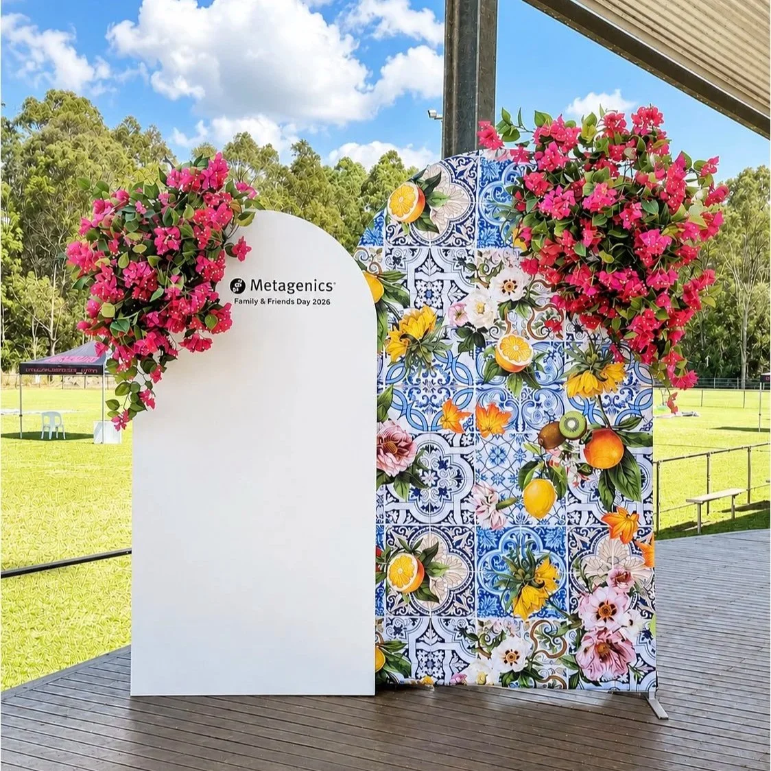 Metagenics Family & Friends Day 2026 personalised arch backdrop, Positano themed Italian backdrop and faux floral arrangements for hire at Print Candy in Brisbane
