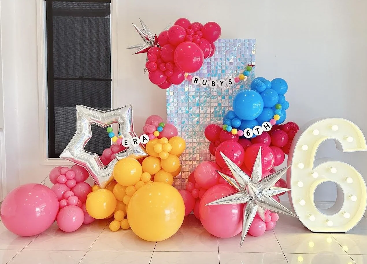 Taylor Swift themed 6th birthday, featuring a light up number 6 surrounded by Swiftie themed balloons, friendship bracelets and shimmer wall