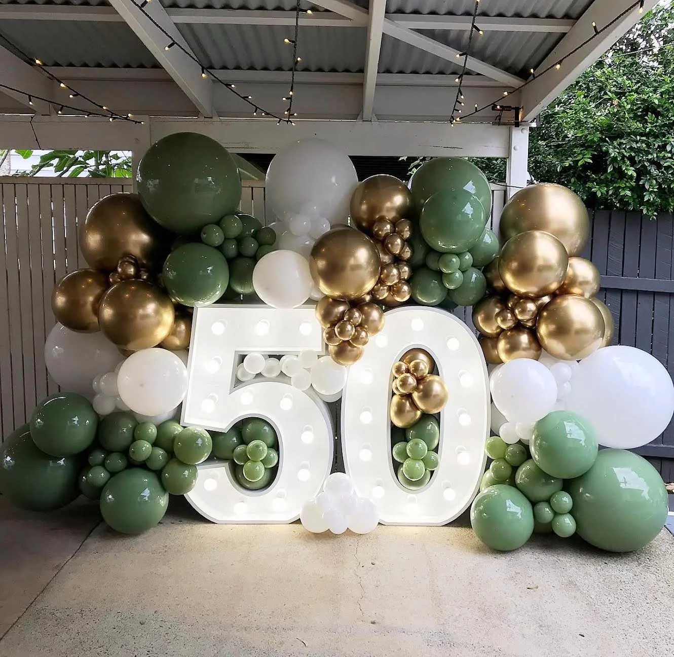 Balloon arrangement with large white illuminated number 50