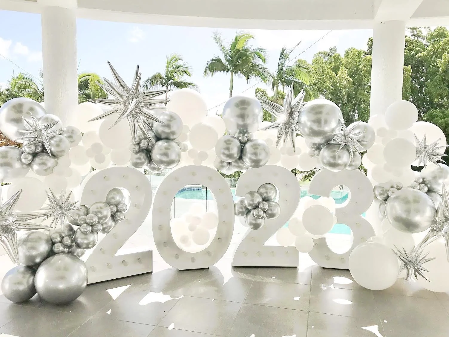 Decorative New Year party decor featuring balloons and light up numbers 