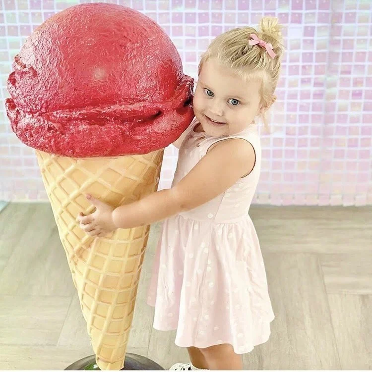 Giant ice cream cone prop with a red scoop and waffle cone design