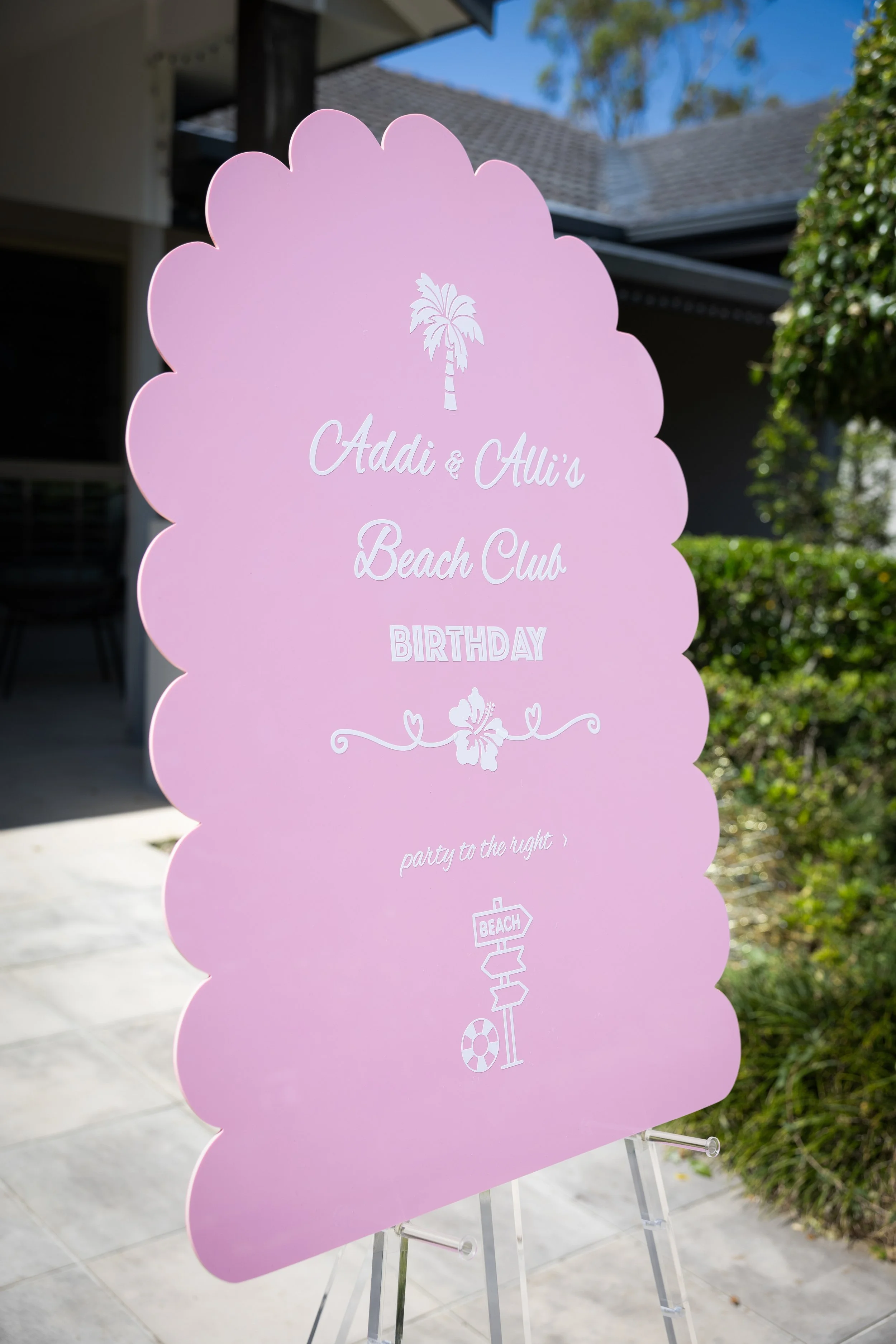 Pink scalloped party sign and clear easel