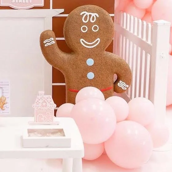 Life size gingerbread boy prop in a festive setting