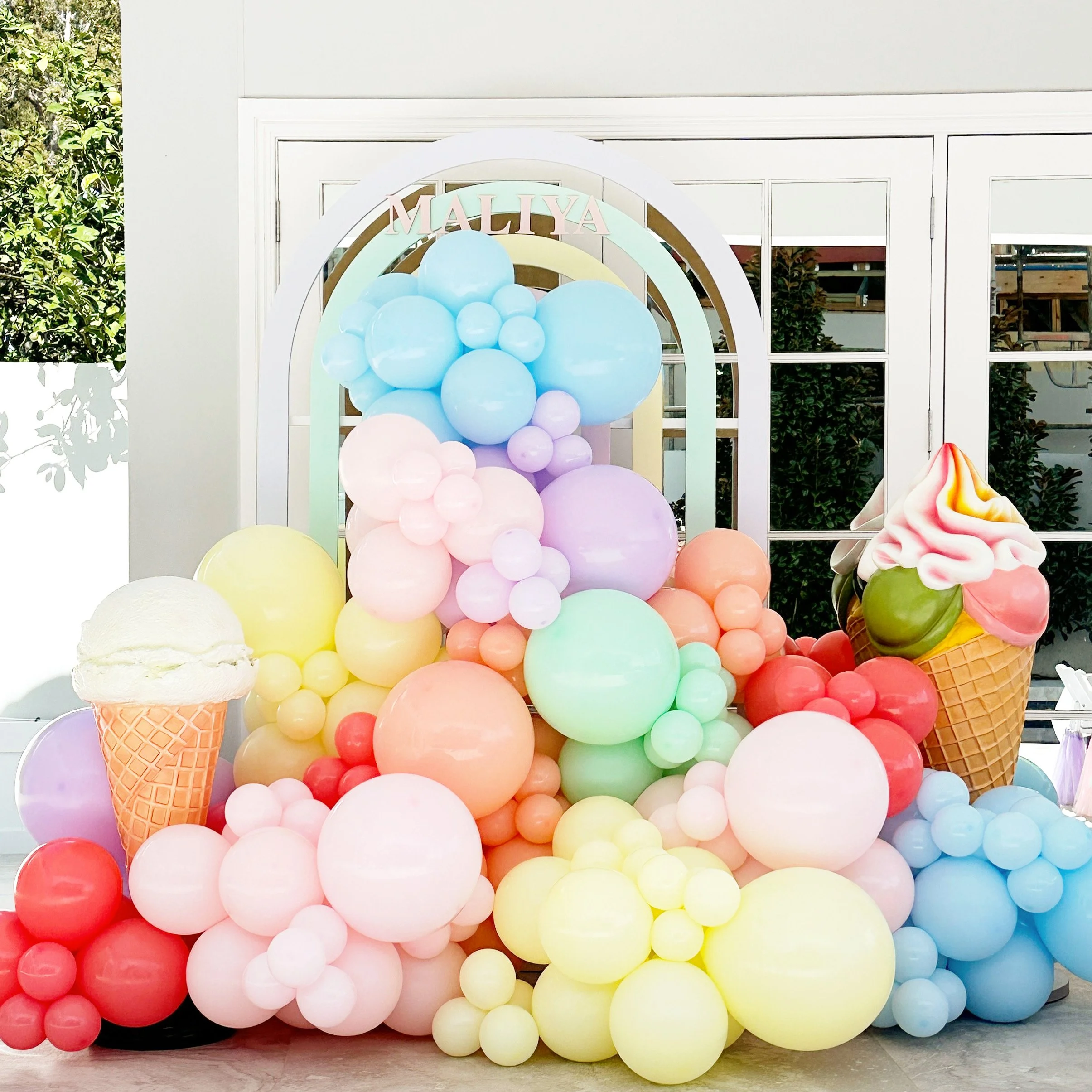 Two Sweet birthday set up with balloons, ice cream props and a pastel arch backdrop