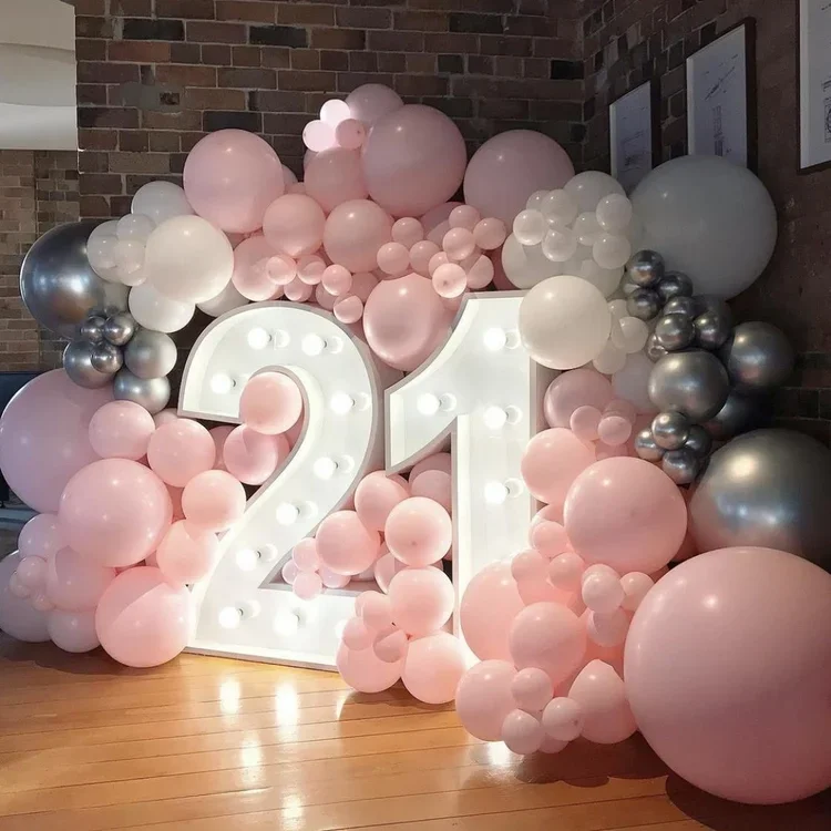 Balloon wall surrounding large illuminated white number 21 for a Twenty First birthday party