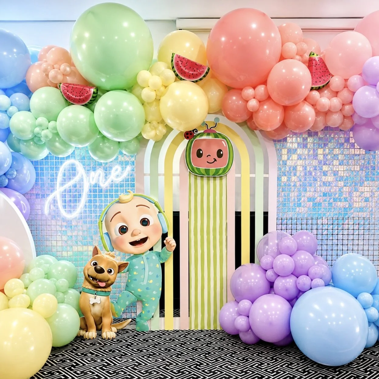 Cocomelon themed kids party with themed balloon garlands, backdrop hire and themed props by Print Candy in Brisbane