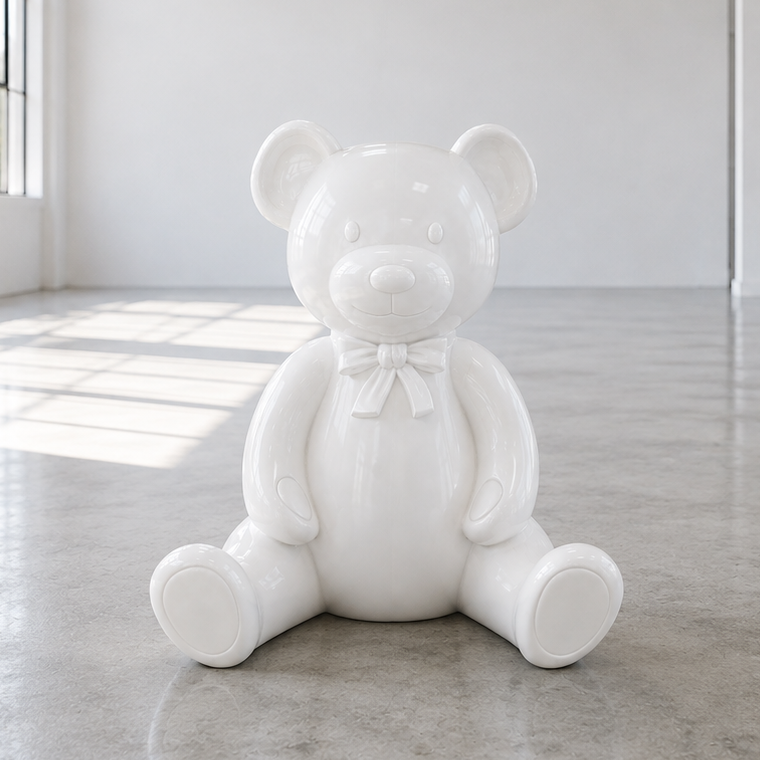 A decorative bear figure with round openings for ears, sitting among pink balloons, with a background of green leafy plants and pink and white flowers.