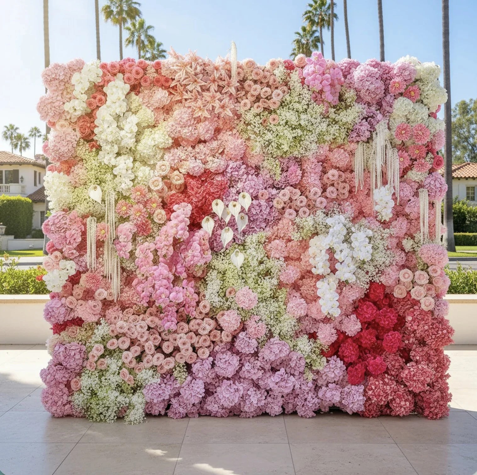 Dripping flower wall featuring baby's breathe, orchids, roses and hydrangeas
