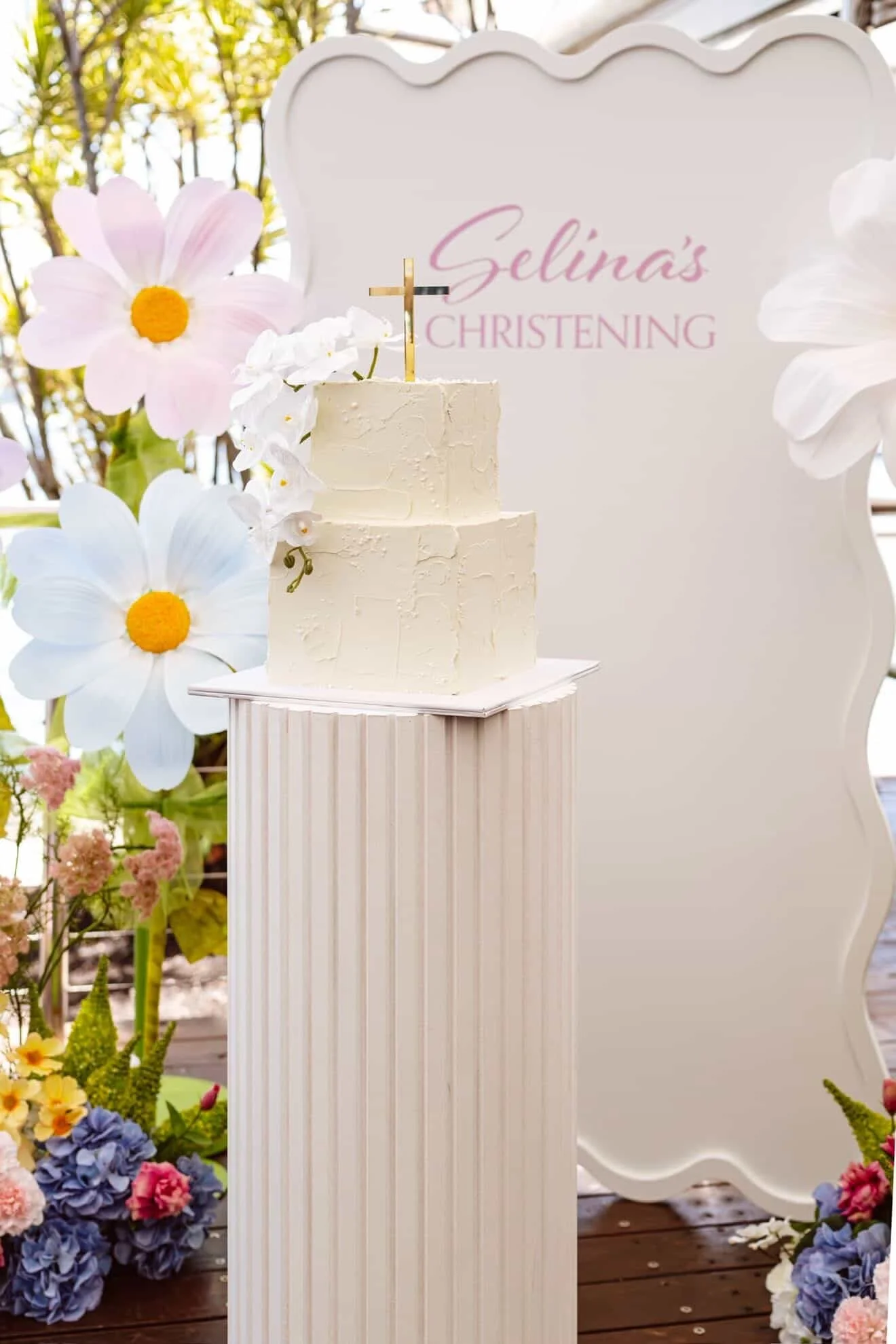 Floral Christening backdrop with faux flower arrangements