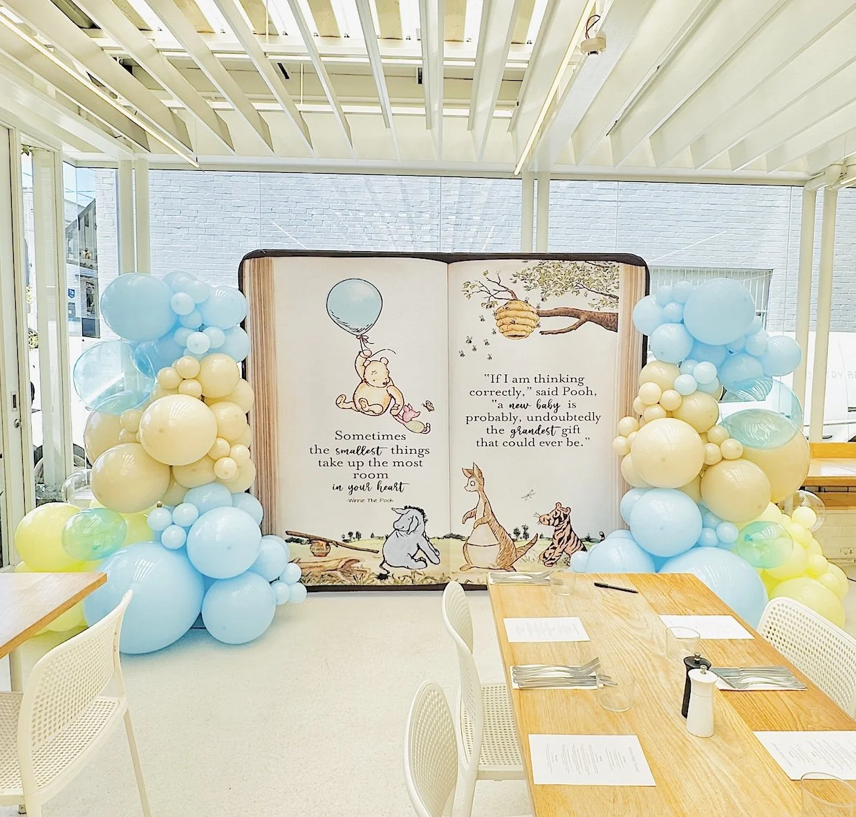 Winnie the Pooh large illustrated storybook backdrop featuring Winnie the Pooh characters and a baby shower quotes