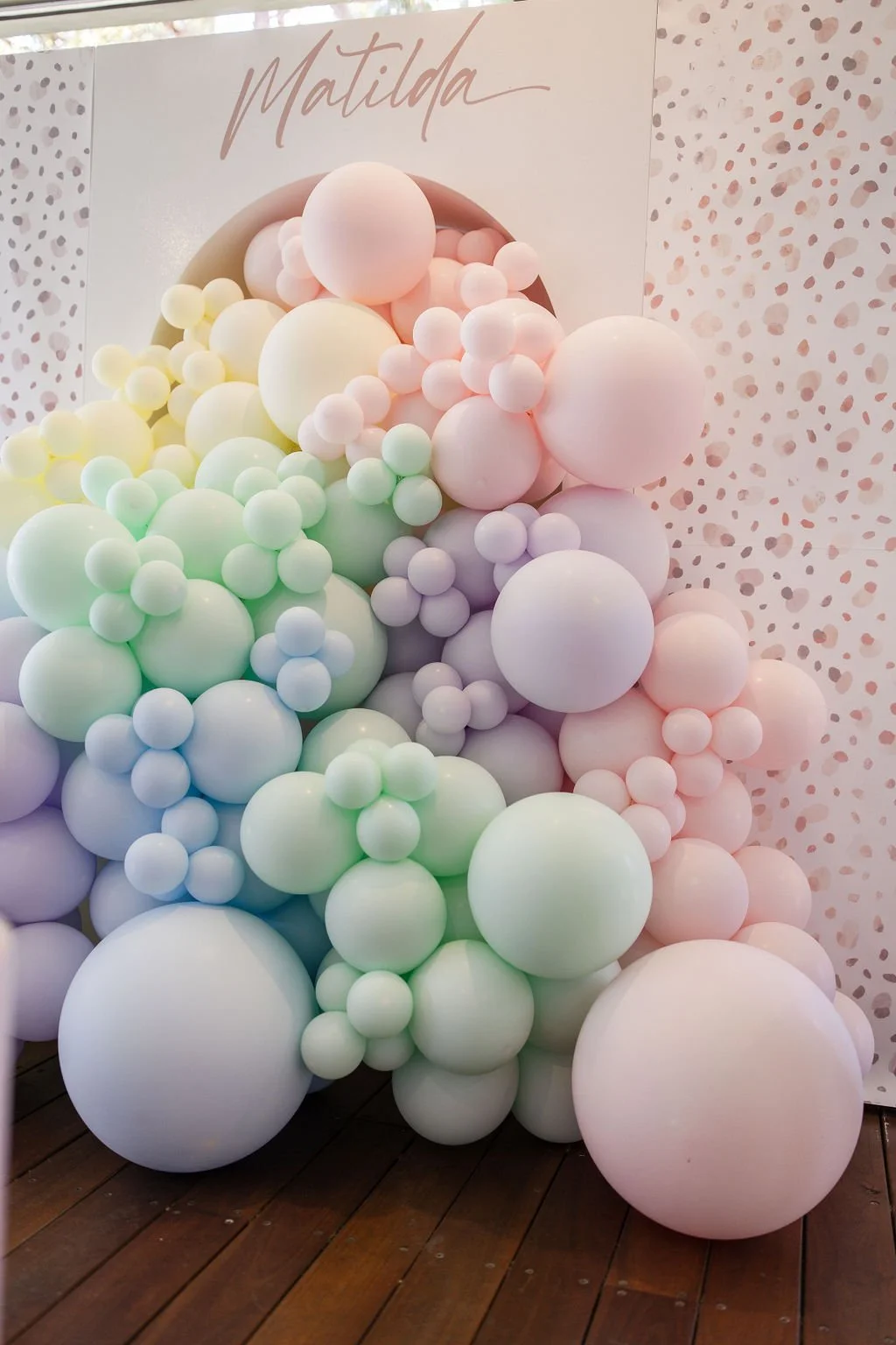 Pastel balloon wall for a floral safari party