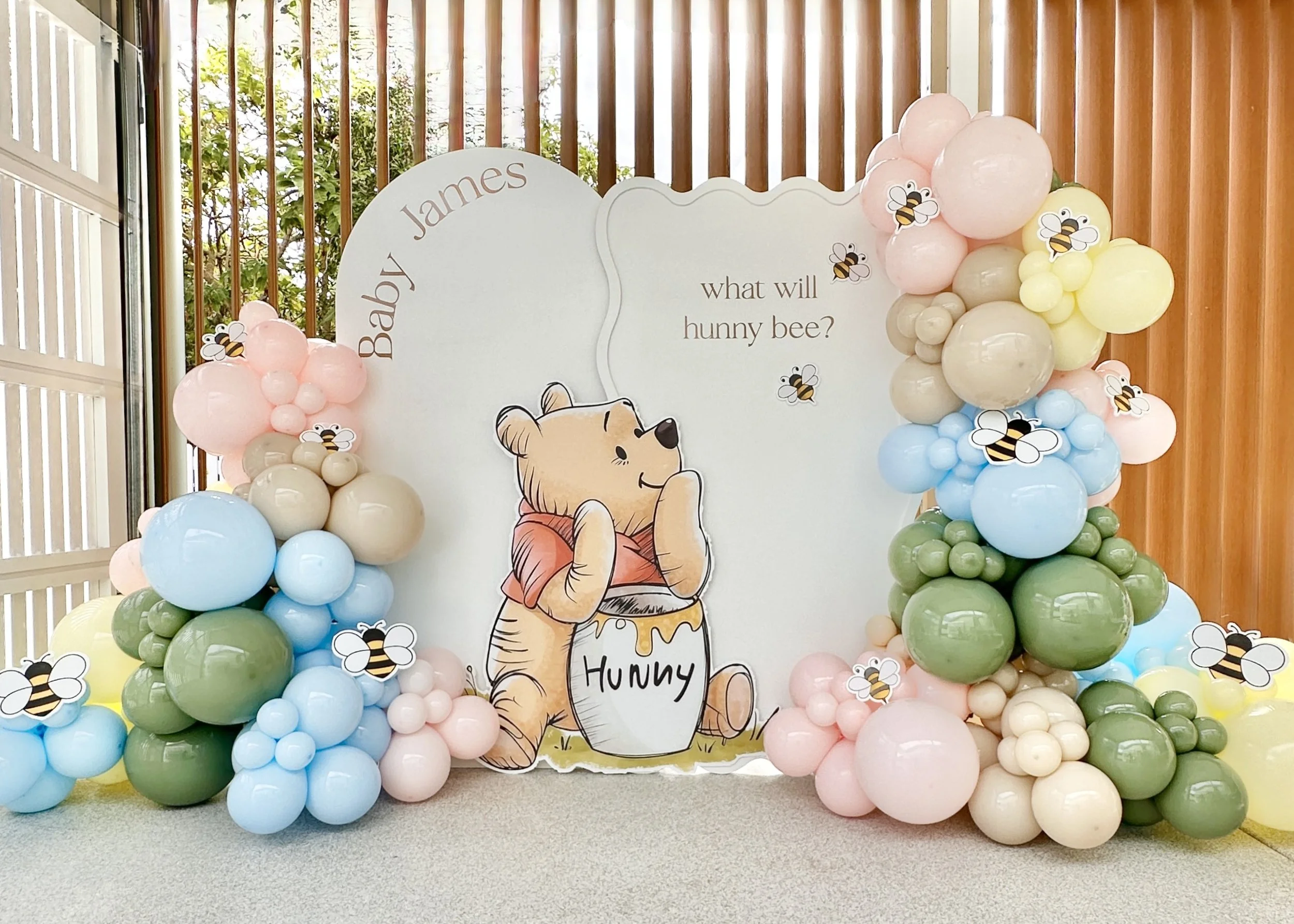 Winnie the Pooh themed baby shower backdrop and balloons