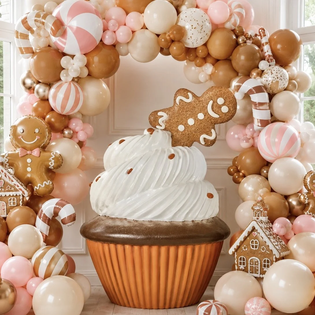 Chocolate cupcake with white frosting, chocolate sprinkles, and a gingerbread cookie on top, decorated with white icing.