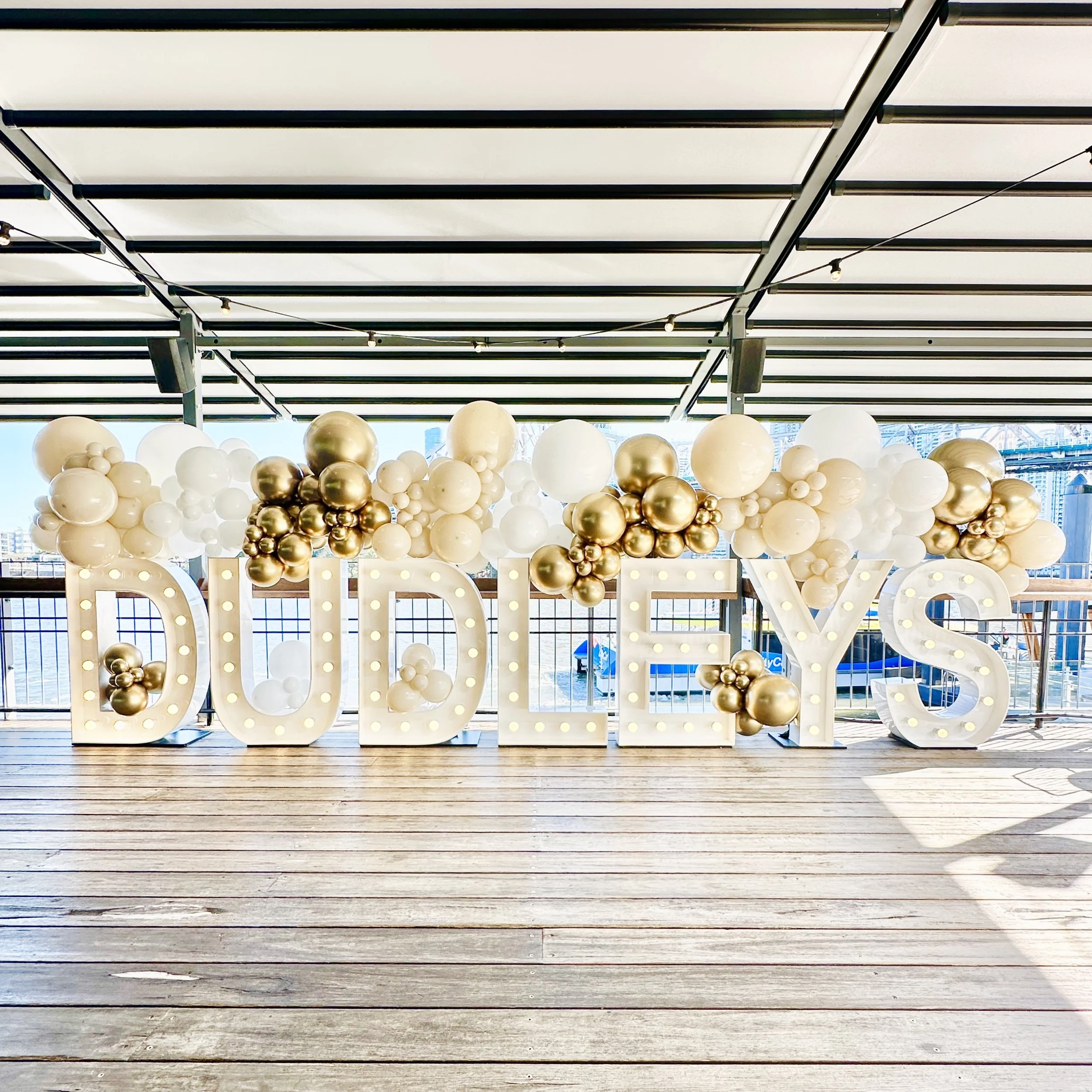 Corporate event backdrop. Decorative display with large illuminated letters and balloon wall