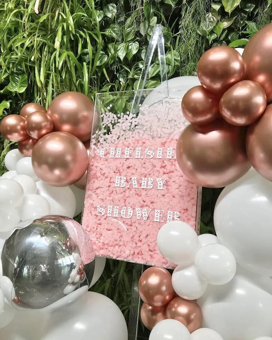 Pink confetti baby shower sign and acrylic easel